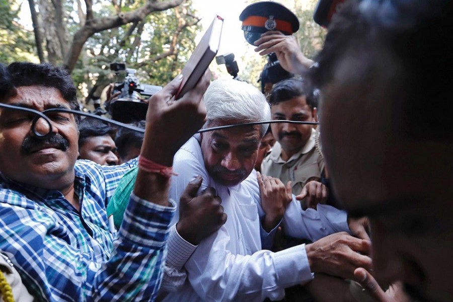 Police escort a man suspected of steering fraudulent loans to companies linked to billionaire jeweller Nirav Modi, at a court in Mumbai, India, February 17, 2018. Reuters