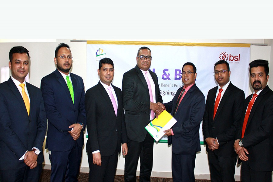 Khorshed Anowar, Head of Business, Retail Banking of EBL (Centre-L) and M.Z.I Dalton Zahir, Head of Sales and Marketing of BSL seen exchanging documents on behalf of their respective sides.