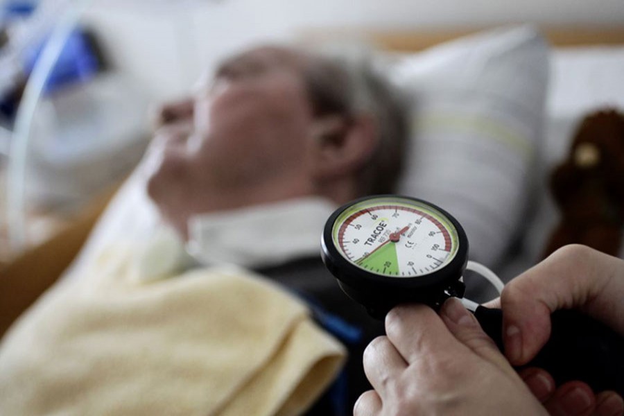 A nurse checks the pressure in the trachea of an 83 year-old man in a permanent vegetative state, the patient has been in this condition since suffering a stroke.- Reuters Photo