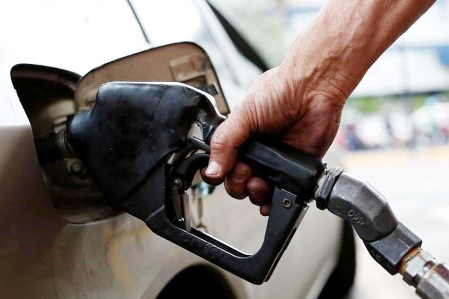 A gas station worker pumps gas into a car at a gas station of the state oil company PDVSA in Caracas, Venezuela. 	— Reuters