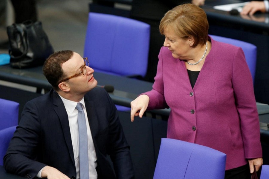 Chancellor Angela Merkel talks to Jens Spahn during debate at the German lower house of parliament Bundestag in Berlin, Germany, February 22, 2018. Reuters