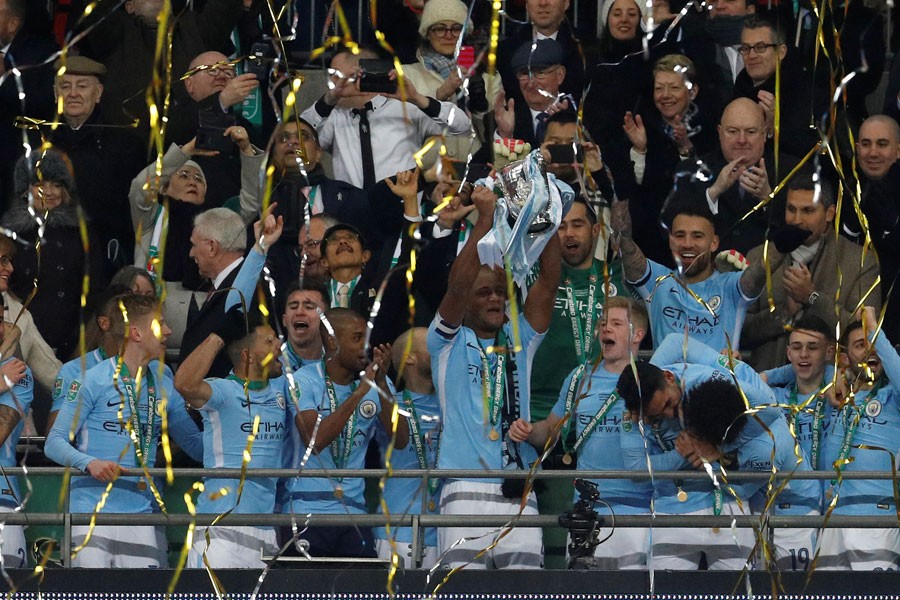 Carabao Cup Final - Arsenal vs Manchester City - Wembley Stadium, London, Britain - February 25, 2018 Manchester City’s Vincent Kompany lifts the trophy as they celebrate winning the Carabao Cup. (Action Images via Reuters)