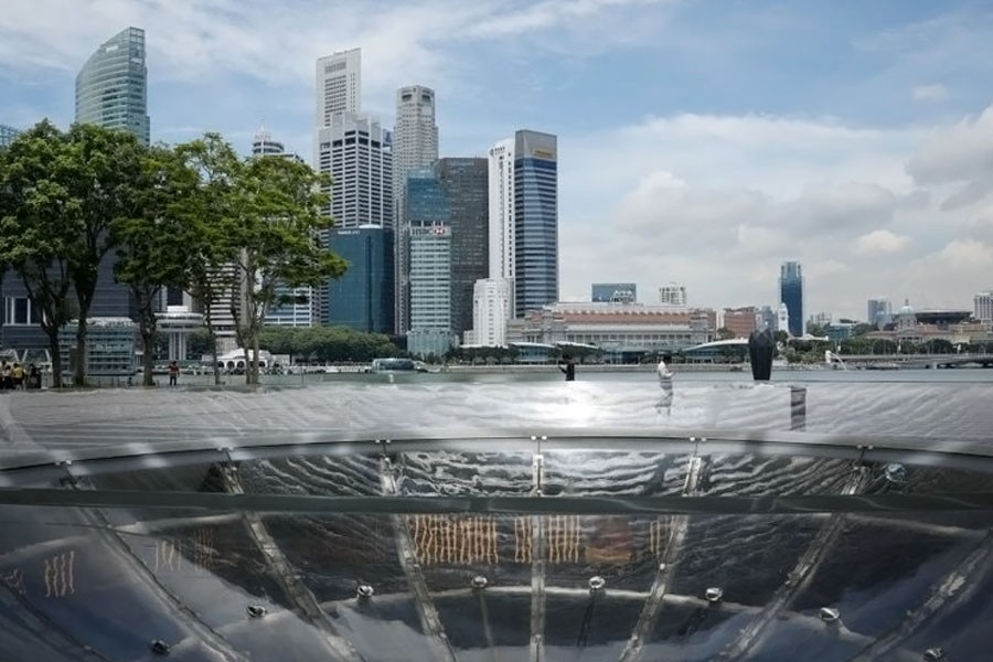 People pass the skyline of Singapore October 11, 2017. (REUTERS)