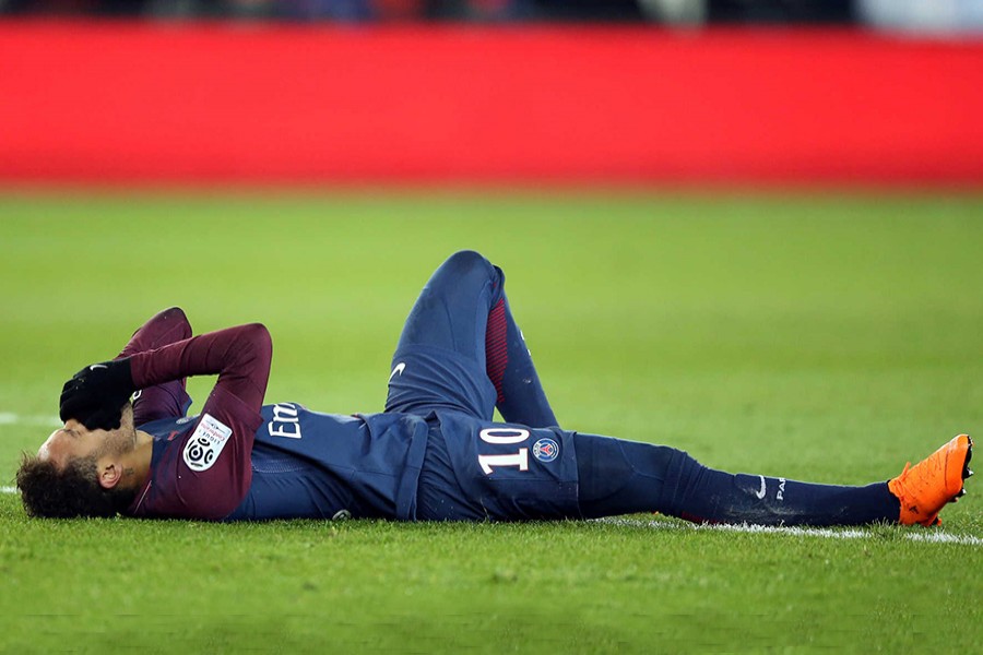 Paris Saint-Germain’s Neymar lies on the pitch after sustaining an injury during their League 1 match against Marseille at the Parc des Princes on Sunday last. - Reuters photo