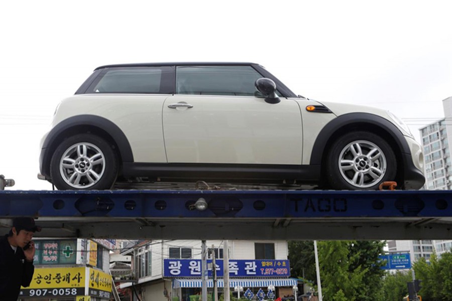 A truck driver checks his truck before transporting BMW's Mini cars in Goyang, north of Seoul on June 12, 2013. - Reuters file photo used for ullustrative purpose only.