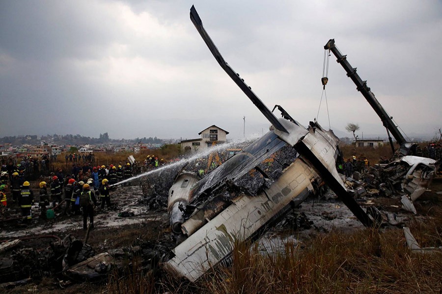 Wreckage of an airplane is pictured as rescue workers operate at Tribhuvan International Airport, Nepal on Monday. - Reuters photo