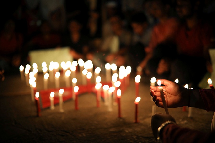 Nepali students of University of Dhaka light candles in memory of the victims of the US-Bangla aircraft crash in Nepal, in Dhaka, Bangladesh on Tuesday. - Reuters photo