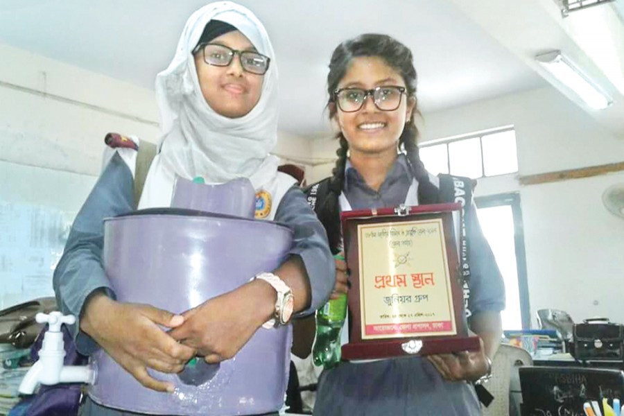 Students with an award in a recently organised  science fair at Dhaka College