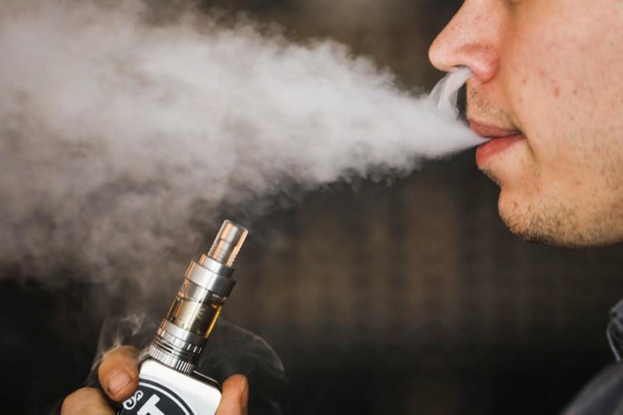 A man smokes an electronic cigarette vaporizer, also known as an e-cigarette, in Toronto, August 7, 2015. Reuters/File