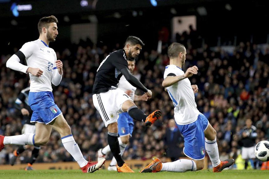 Argentina’s Ever Banega, centre, scores his side’s first goal of the game during the international friendly football match against Italy at the Etihad Stadium in Manchester on Friday. AP photo.