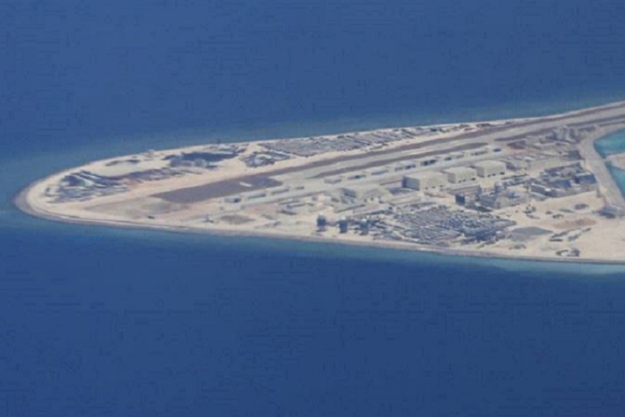 Chinese dredging vessels are purportedly seen in the waters around Mischief Reef in the disputed Spratly Islands in the South China Sea in this still image from video taken by a P-8A Poseidon surveillance aircraft provided by the United States Navy May 21, 2015. US Navy/Handout via Reuters/File Photo