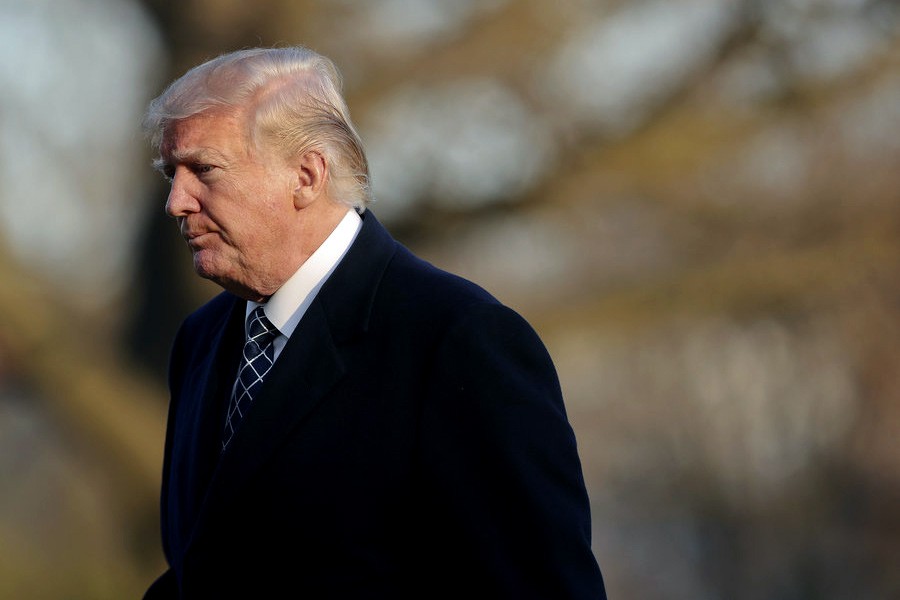 Donald Trump walking across the South Lawn of the White House on Sunday. -NPR Photo