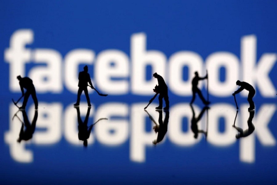 Figurines are seen in front of the Facebook logo in this illustration taken March 20, 2018. Reuters