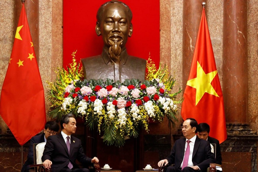 China's State Councilor and Foreign Minister Wang Yi (L) chats with Vietnam's Deputy Prime Minister and Foreign Minister Pham Binh Minh after a news conference at the Government Guesthouse in Hanoi, Vietnam April 1, 2018. Reuters