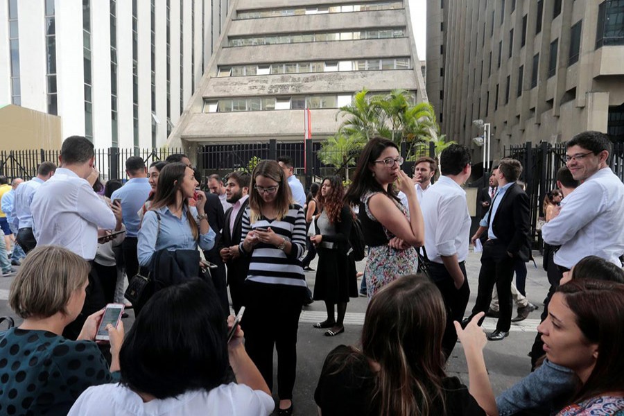 People gather outside a building that was temporarily evacuated in Sao Paulo, Brazil following a strong earthquake on Monday - Reuters photo