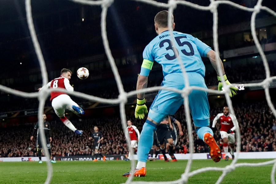 Arsenal's Aaron Ramsey scores their third goal during the Europa League quarterfinal, first leg soccer match against CSKA Moscow at the Emirates stadium in London Thursday	— Reuters