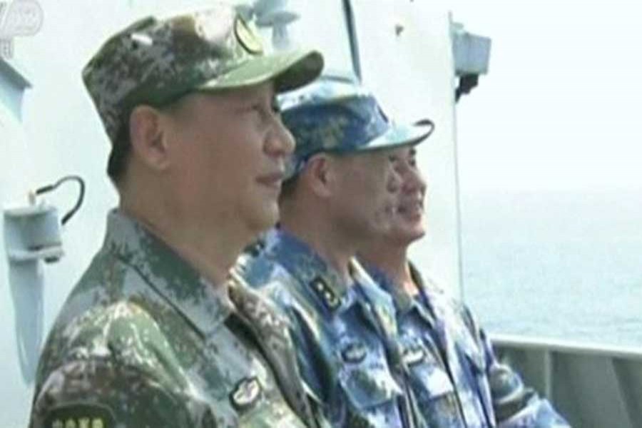 Chinese leader Xi Jiping inspects troops at a undisclosed location in the South China Sea. Reuters