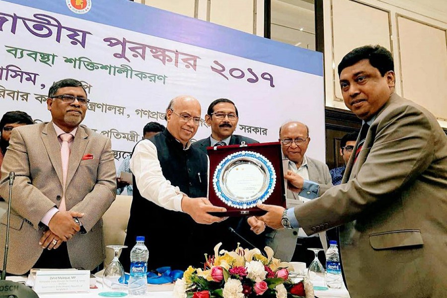 Shaheed Suhrawardy Medical College Hospital Director Prof. Dr. Uttam Kumar Barua receiving the award from Health Minister Mohammad Nasim