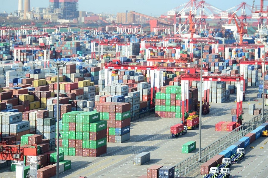 Shipping containers are seen piled up at a port in Qingdao, Shandong province, China April 13, 2018. China Daily via Reuters/Files