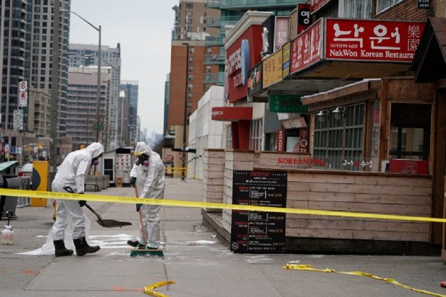 Workers clean up blood stains on Yonge Street following a van that attacked multiple people in Toronto, Ontario, Canada, April 24, 2018. Reuters/File Photo