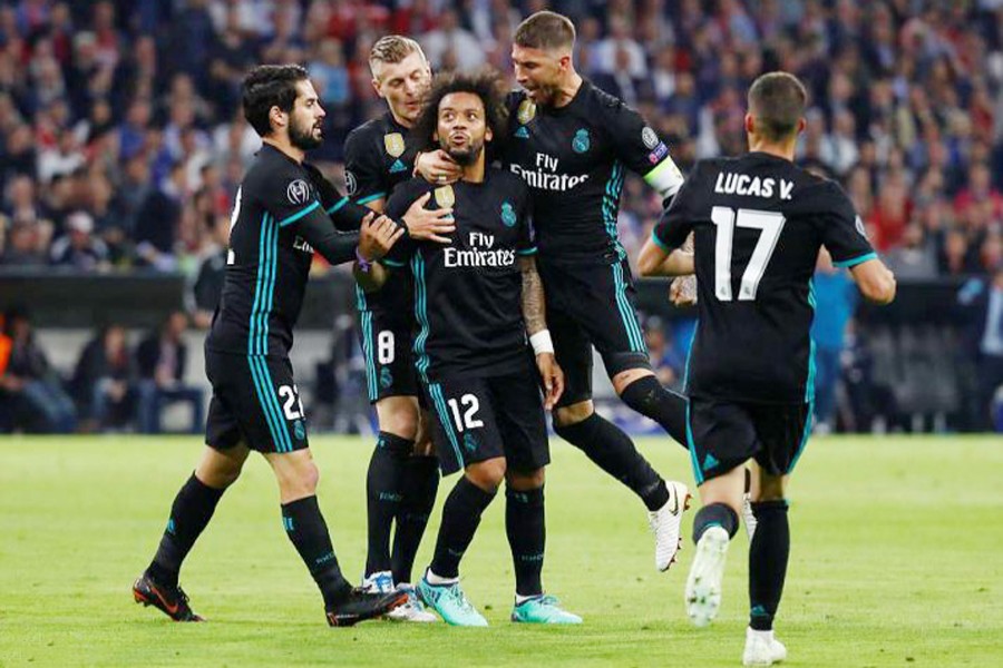 Madrid's Marcelo, centre, is congratulated by his teammates after scoring his side's first goal during the Champions League first leg semifinal soccer match against FC Bayern Munich in Munich, southern Germany on Wednesday	— Reuters