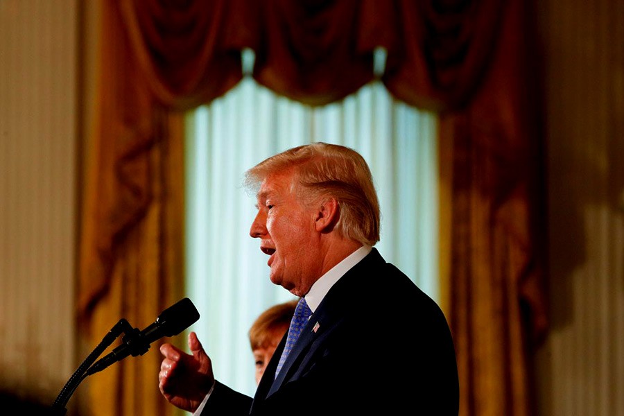 US President Donald Trump addressing a a joint news conference with German Chancellor Angela Merkel at the White House in Washington on Friday. -Reuters Photo