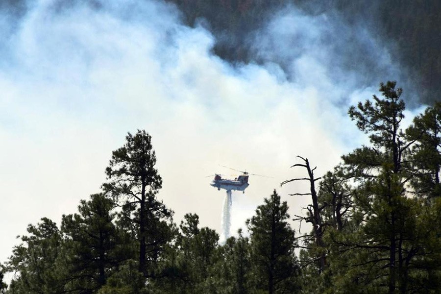 Photo provided by the US Forest Service shows a helicopter fighting a wildfire in north-central Arizona on Monday - via Associated Press