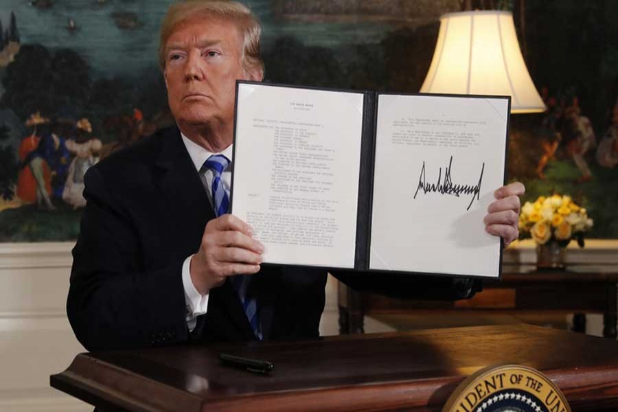 US President Donald Trump displays a presidential memorandum after announcing his intent to withdraw from the JCPOA Iran nuclear agreement in the Diplomatic Room at the White House in Washington, US, May 8, 2018. Reuters