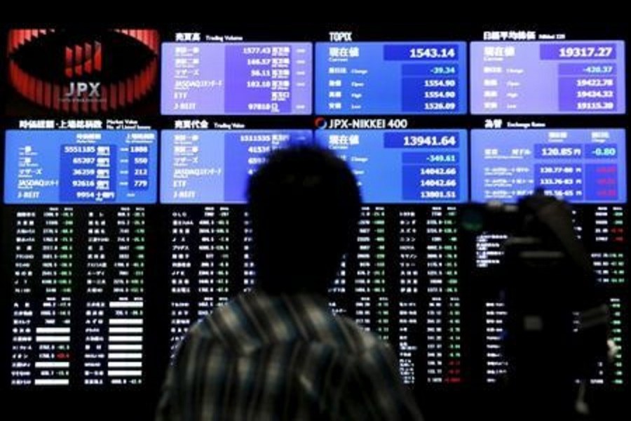 A videographer films an electronic board showing the Japan's Nikkei average (Top R) and related indexes at the Tokyo Stock Exchange (TSE) in Tokyo, Japan, July 9, 2015. Reuters/Files