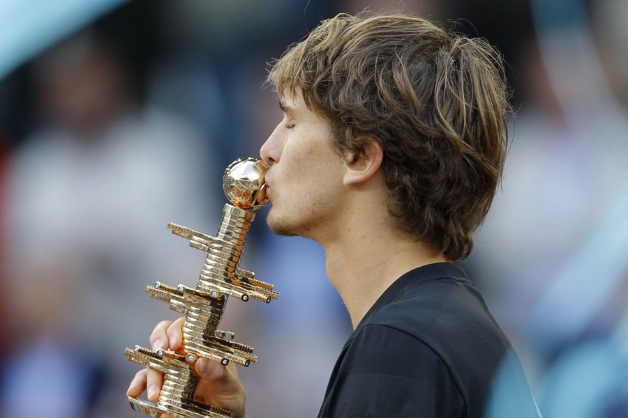 Alexander Zverev of Germany kissing the trophy after defeating Dominic Thiem of Austria during the men's final of the Madrid Open Tennis tournament at Madrid in Spain on Sunday	— AP