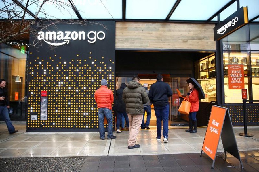 People are offered free reusable bags as they enter the new Amazon Go store at Amazon's Seattle headquarters in Seattle, Washington, US, January 29. Reuters/File