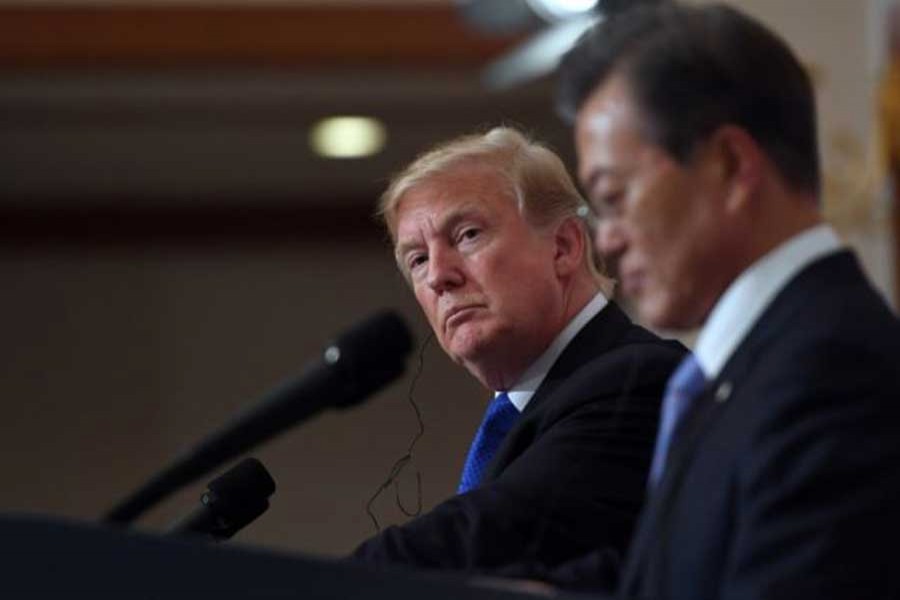 US President Donald Trump and South Korea's President Moon Jae-in shake hands during a joint press conference at the presidential Blue House in Seoul, South Korea, November 7, 2017. Reuters/Files