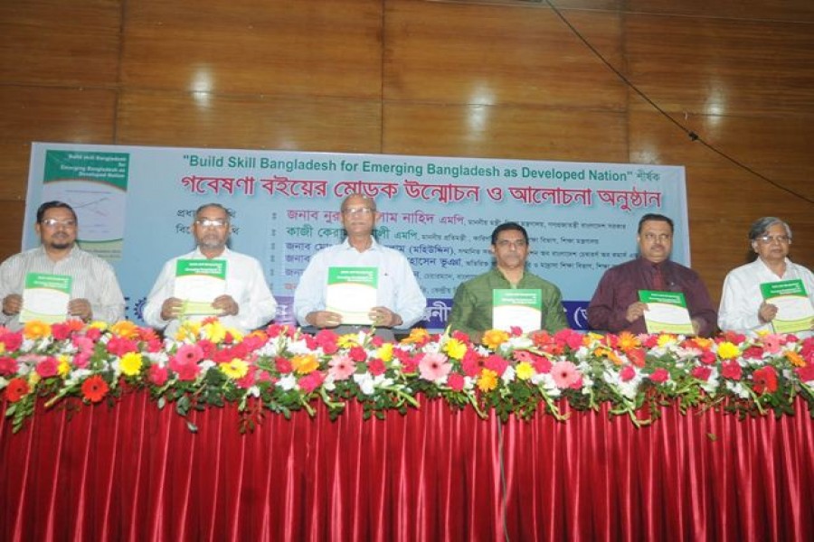 Participants holding the Research anthology titled ‘Build Skill Bangladesh for Emerging Bangladesh as Development Nation’ which was unveiled at IDEB in the city on Sunday. Photo: UNB