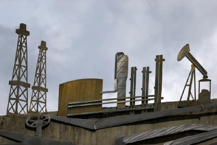 Cut-outs depicting images of oil operations are seen outside a building of Venezuela's state oil company PDVSA in Caracas, Venezuela, June 14, 2016. REUTERS/Ivan Alvarado/File Photo