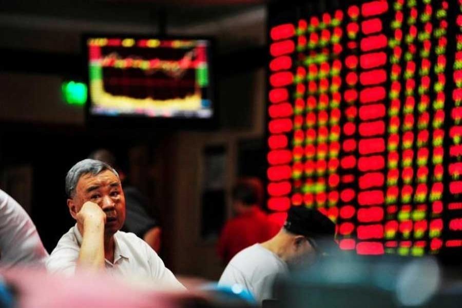 An investor sits in front of an electronic board showing stock information at a brokerage house in Nanjing, Jiangsu province, China, September 27, 2016. Reuters/Files