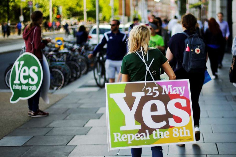 A woman carries a placard as Ireland holds a referendum on liberalising abortion laws, in Dublin, Ireland, May 25. Reuters/File