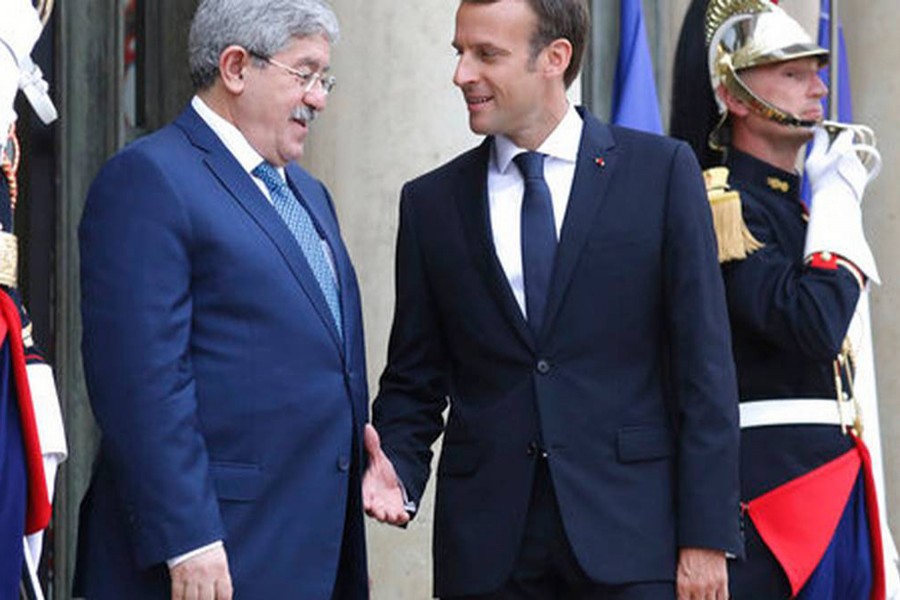 French President Emmanuel Macron (right) welcoming Algerian Prime Minister Ahmed Ouyahia during a meeting in Paris on Tuesday	— AP