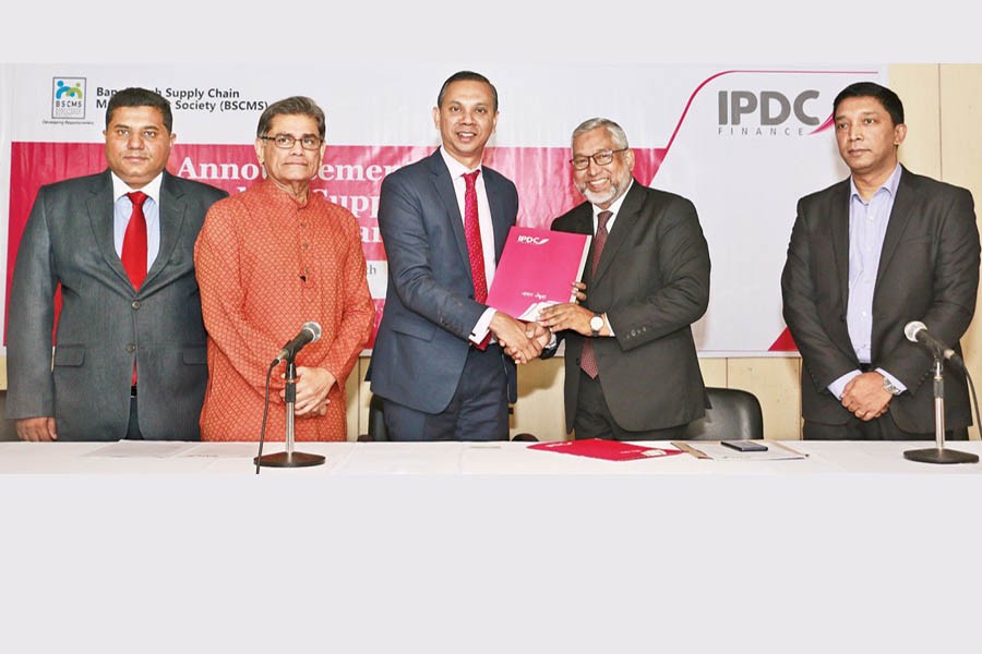 Managing Director and CEO of IPDC Finance Limited Mominul Islam and Director of Corporate Affairs of Nestle Bangladesh Limited Naquib Khan exchanging documents on Wednesday