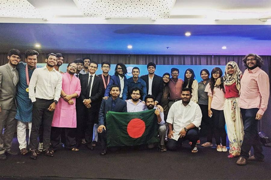 Bangladeshi debaters with the winning team holding the flag at UADC 2018