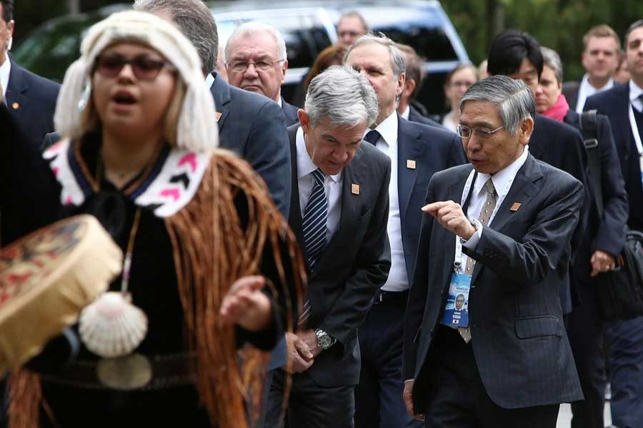 Governor of the Bank of Japan Haruhiko Kuroda (R) speaks with Chair of the Federal Reserve Jerome Powell while arriving at the welcome reception dinner during the G7 Finance Ministers Summit in Whistler, British Columbia, Canada, May 31, 2018. Reuters/Files