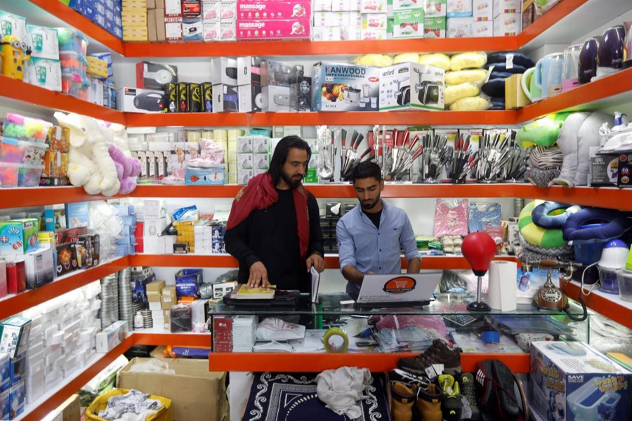 Afghan shopkeepers work on their laptop at their online shop in Kabul, Afghanistan June 4. Reuters/File Photo