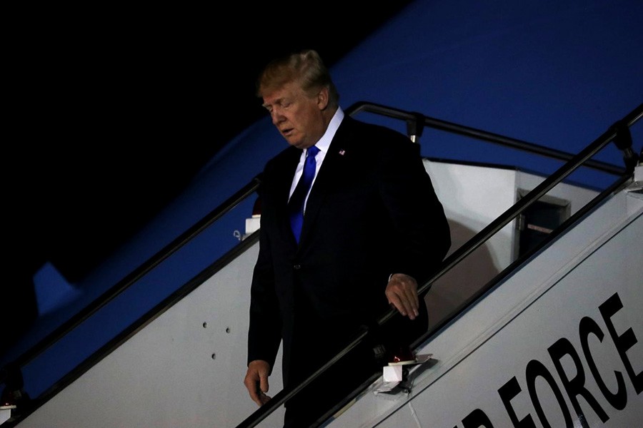 US President Donald Trump disembarks Air Force One as he reaches Singapore on Sunday. -Reuters Photo