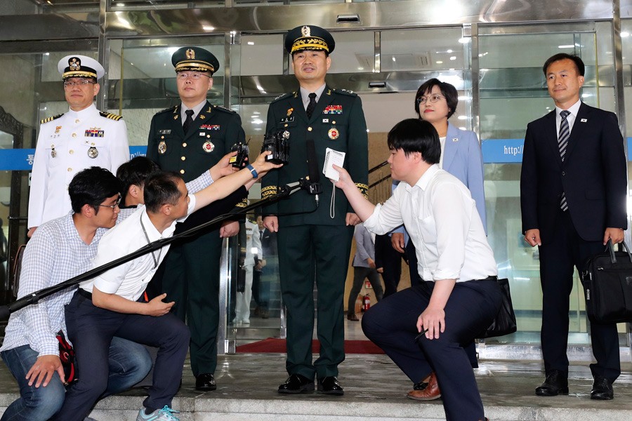 South Korean Maj. Gen. Kim Do-gyun, centre, speaks to the media before leaving for the border village of Panmunjom to attend South and North Korea meeting on June 14, 2018. AP.