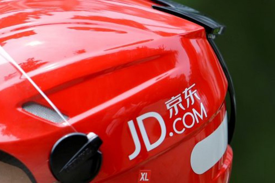 A logo of JD.com is seen on a helmet of a delivery man in Beijing, China June 16, 2014. Reuters/File Photo