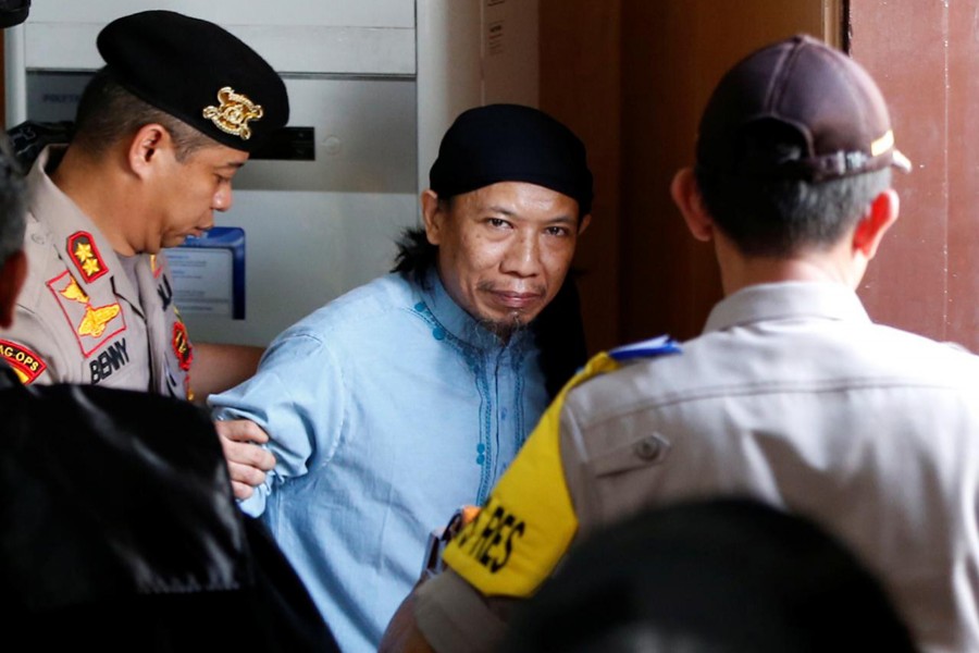 Islamic cleric Aman Abdurrahman leaves a court following his verdict in Jakarta, Indonesia, June 22. Reuters/File Photo