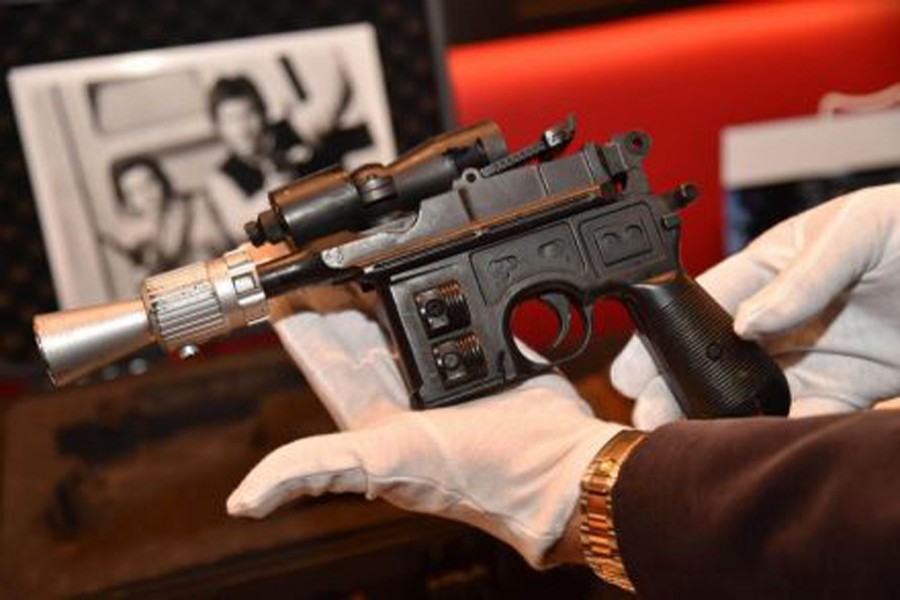 The BlasTech DL-44 blaster used by Han Solo, played by Harrison Ford, from the Star Wars trilogy film 'Return of the Jedi' pictured moments before the auction. Photo: The Business Times