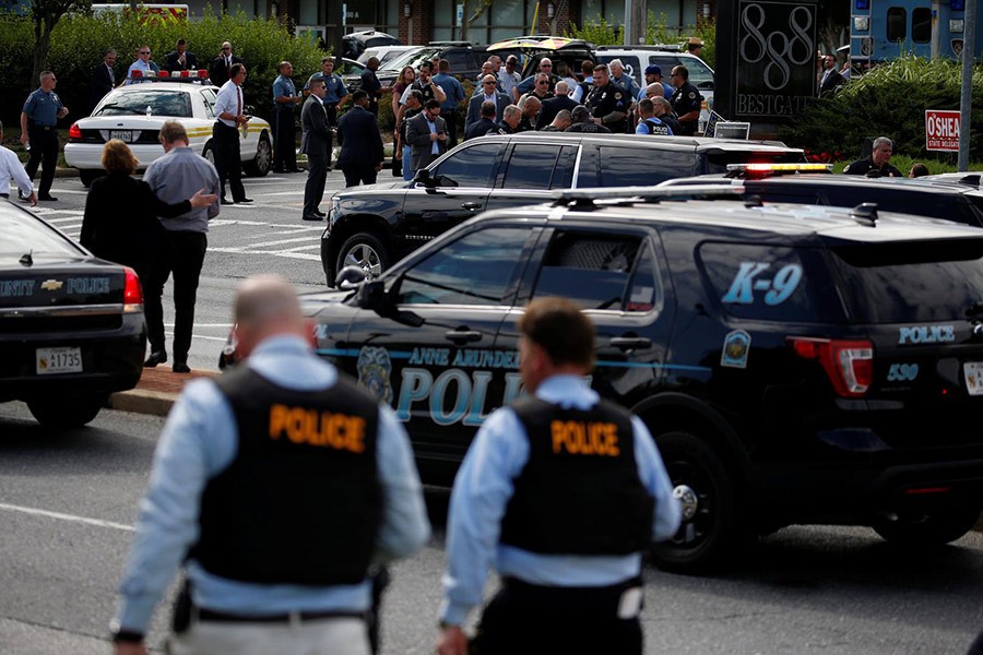 Law enforcement officials survey shooting scene at Capital Gazette newspaper in Annapolis, Maryland, US on Thursday - Reuters photo