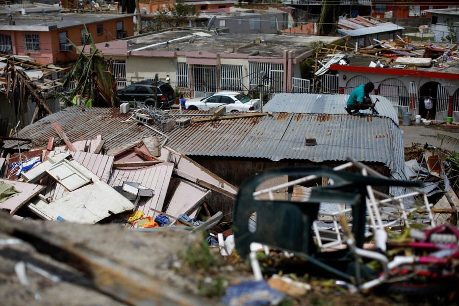 A man tries to rebuild his house after the area was hit by Hurricane Maria in Canovanas, Puerto Rico. Reuters/Files