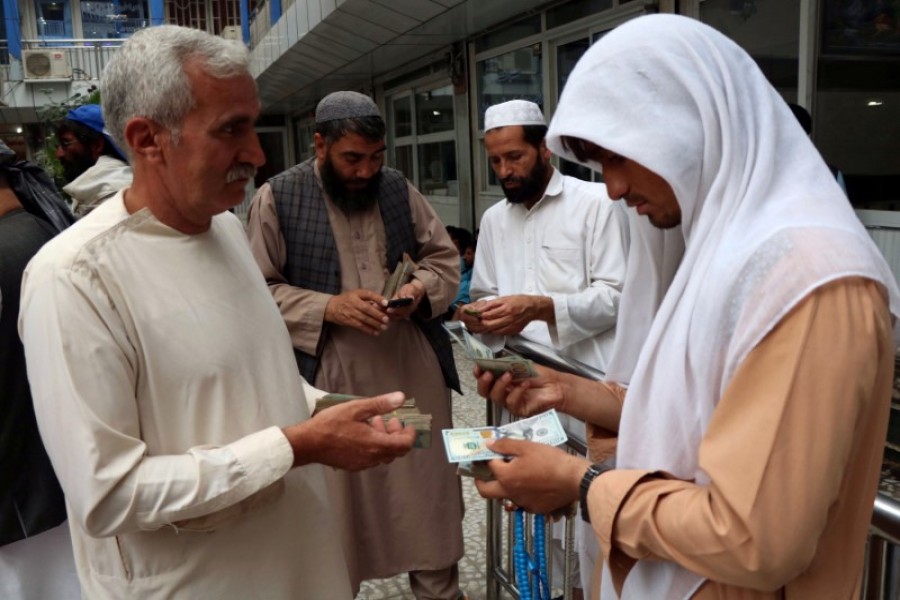 Afghan money changers gather to deal with foreign currency at a money change market in Herat province, Afghanistan, June 3, 2018. Reuters/Files