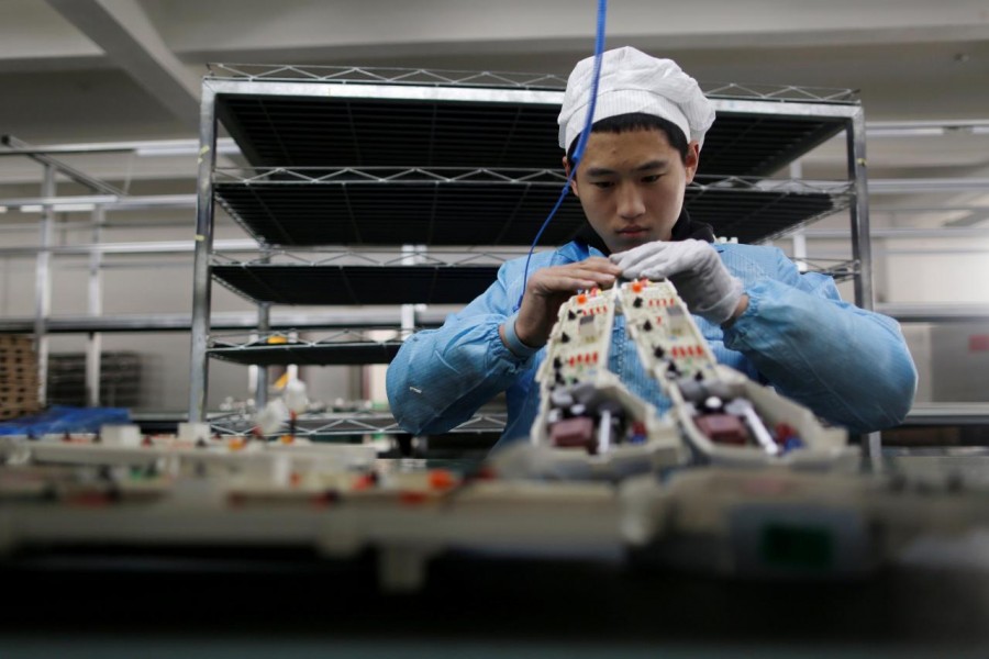 A labourer works inside an electronics factory in Qingdao, Shandong province, China, January 29, 2018. Reuters/File Photo